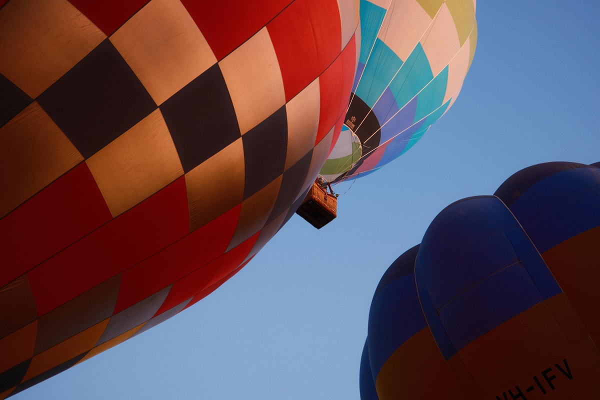 Colorful balloons in the sky during Canberra Balloon Spectacular 2024.